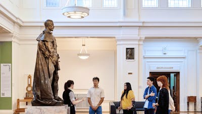 A group of people stand in King's Hall