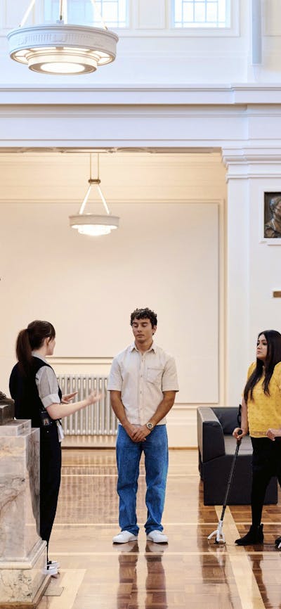 A group of people stand in King's Hall