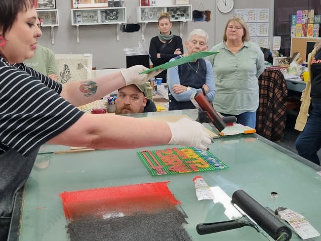 open day in printmaking studio, rolling ink onto Lego baseplate