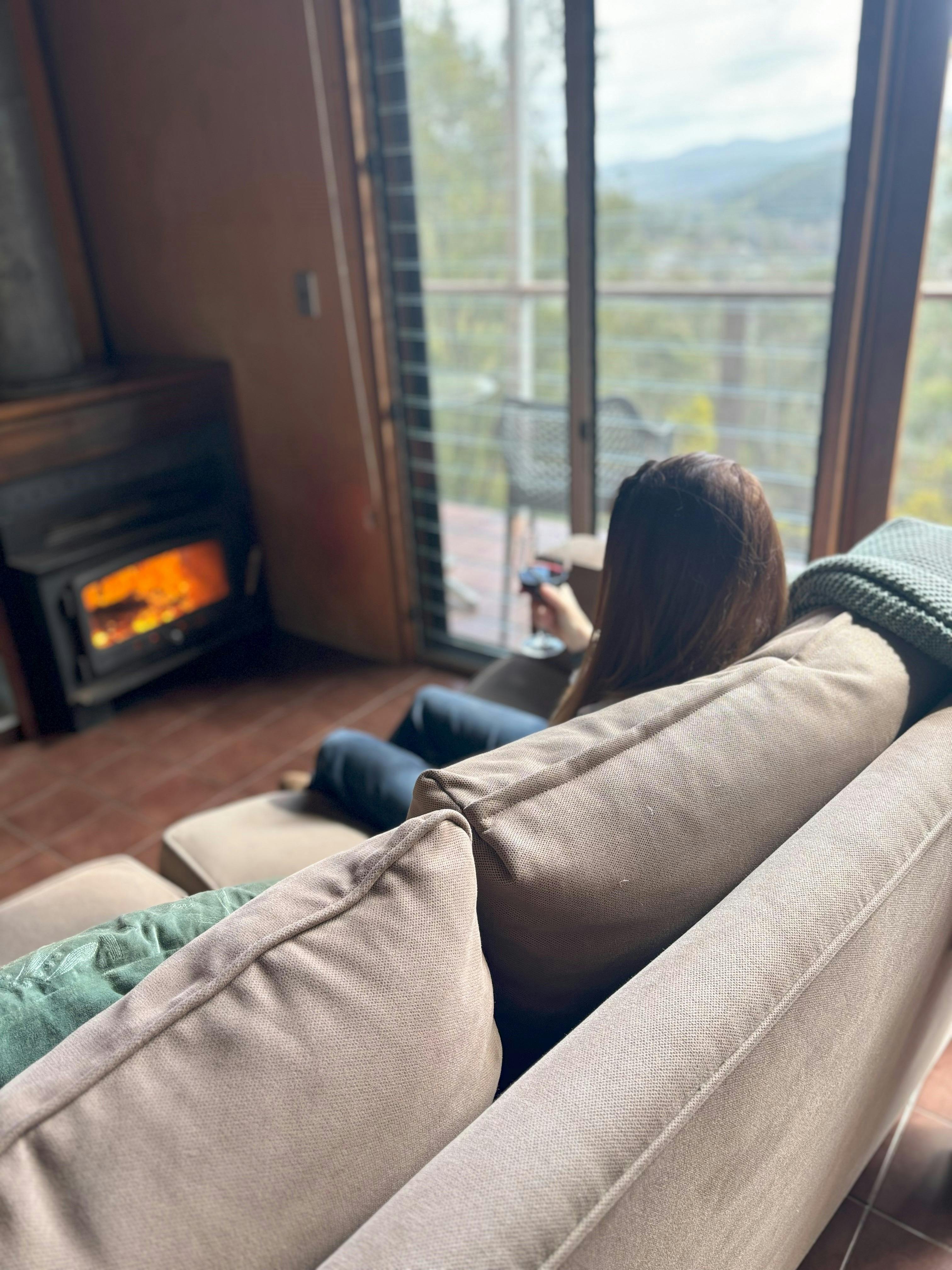 Relaxing by the fire and admiring the views down the Ovens Valley