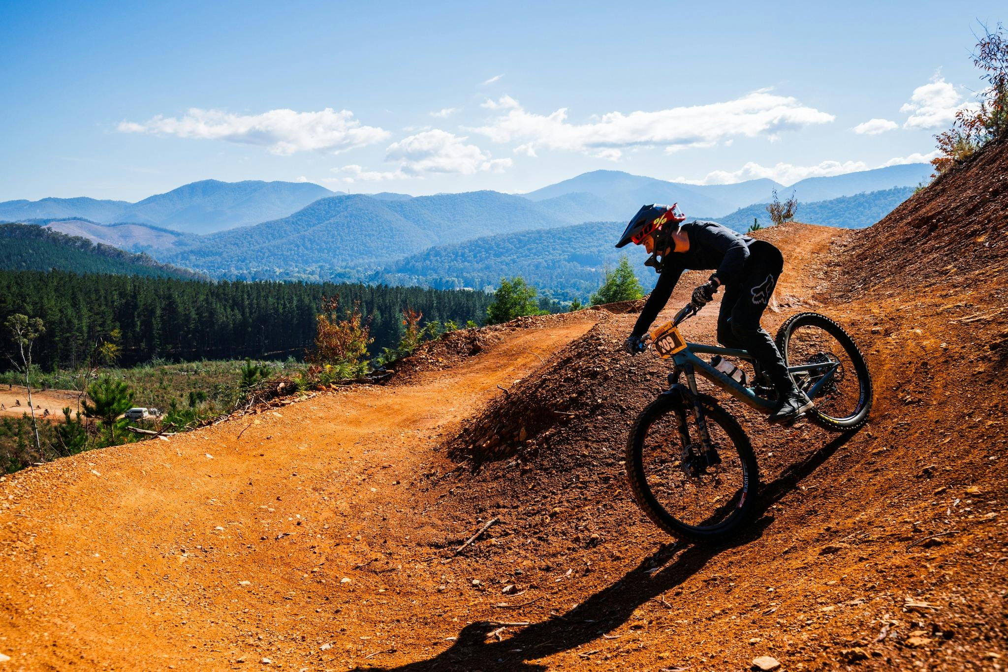 Cyclist off road on single trail in Bright with mountain backdrop