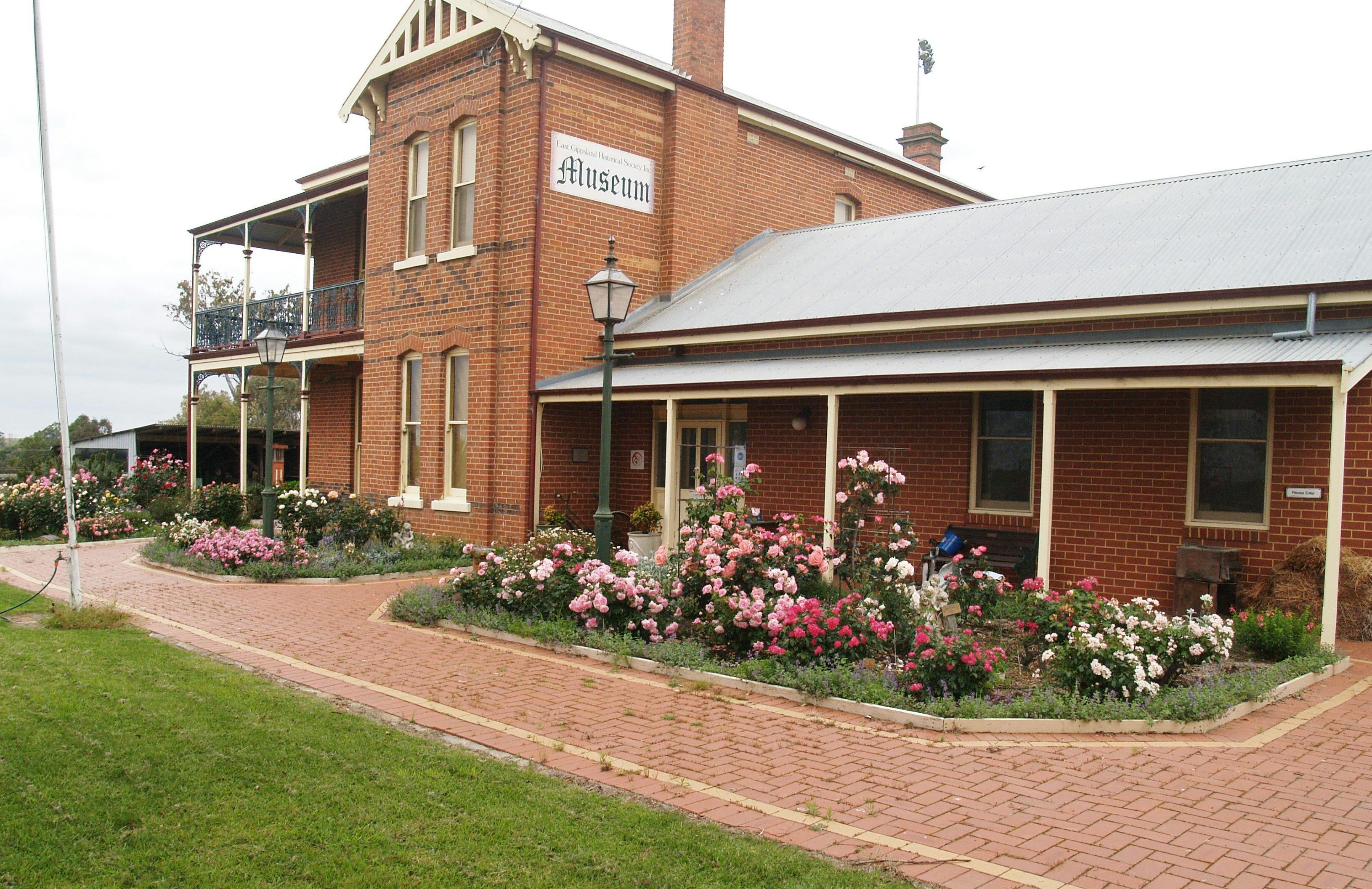 The museum with Australian bred rose gardens in front and  2 converted old style gas lights