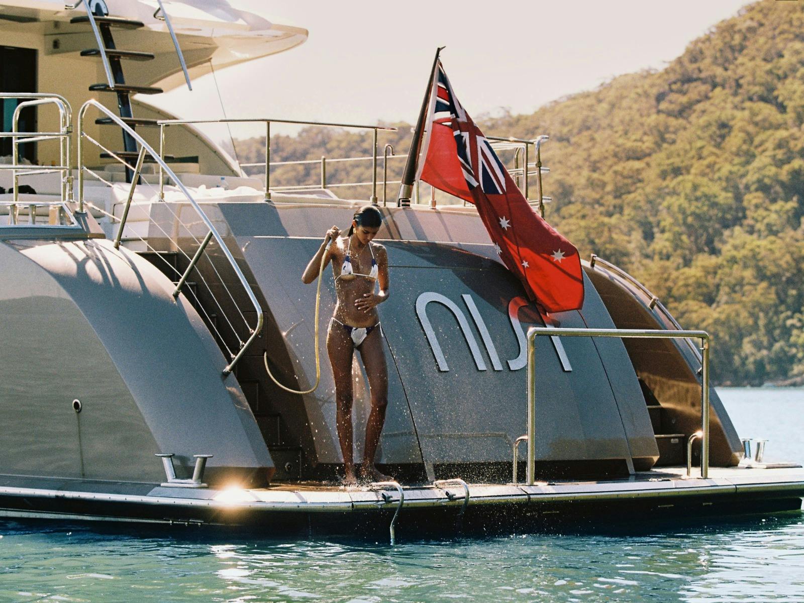 Nisi - girl in bikini on stern having a shower