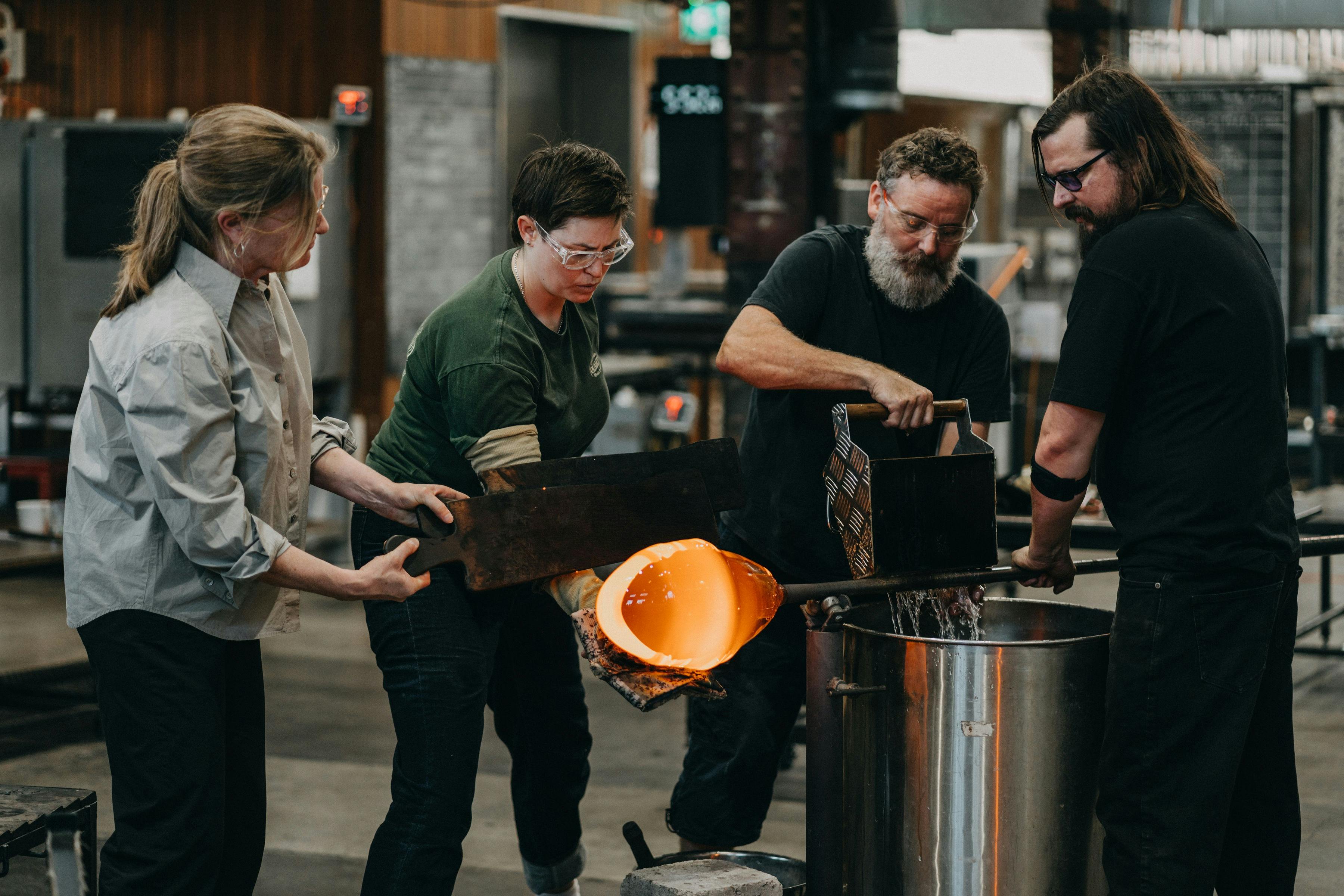 Four artists cooling the pipes in the Glassowrks Hotshop