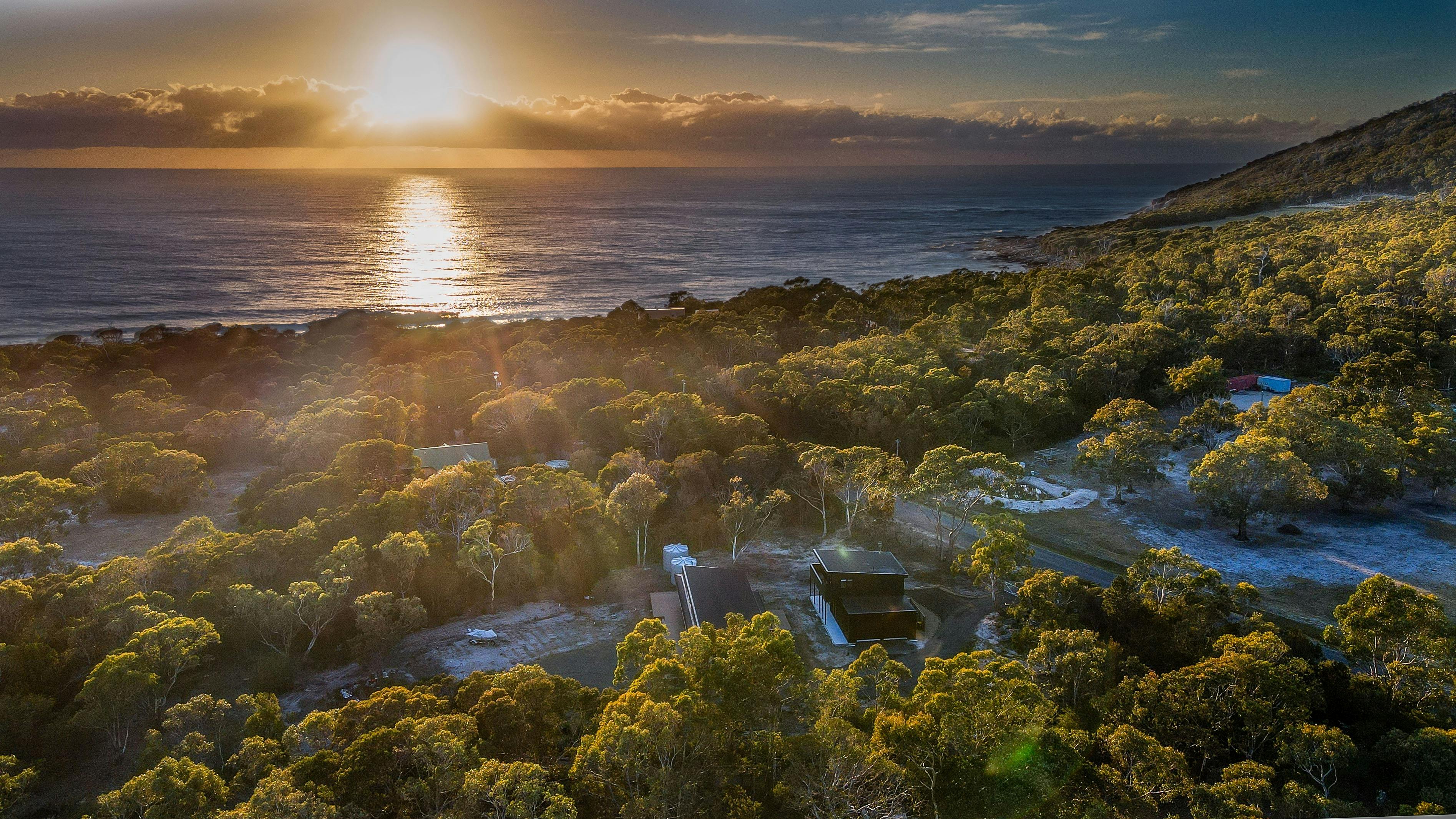Aerial image of where the tiny home is located in a bush area near the ocean
