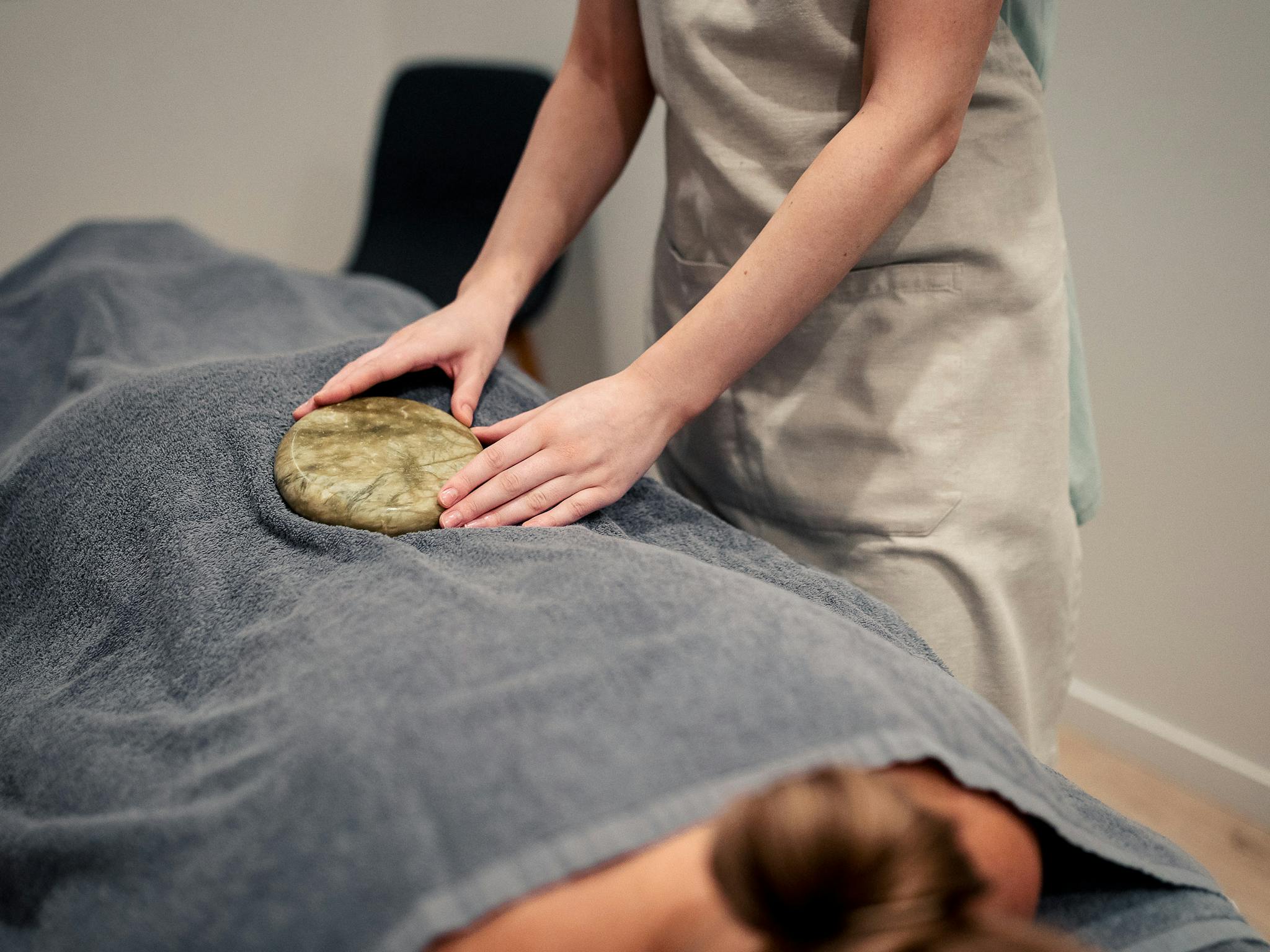 therapist holding warm jade stone