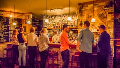 Young people lined up at the bar for cocktails