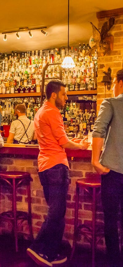 Young people lined up at the bar for cocktails