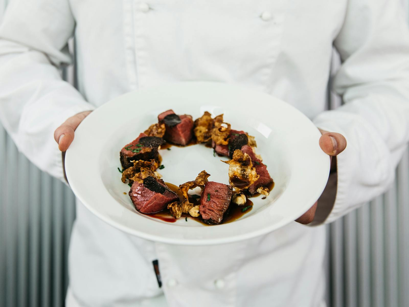 Chef holding a beautiful dish made with truffles