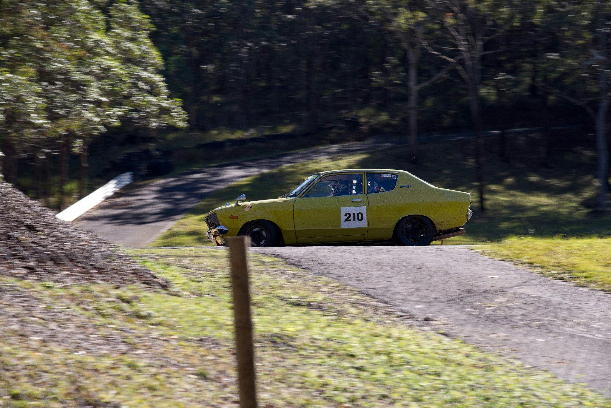 View from the start line of a Datsun 120Y turbo entering the hairpin from the first loop