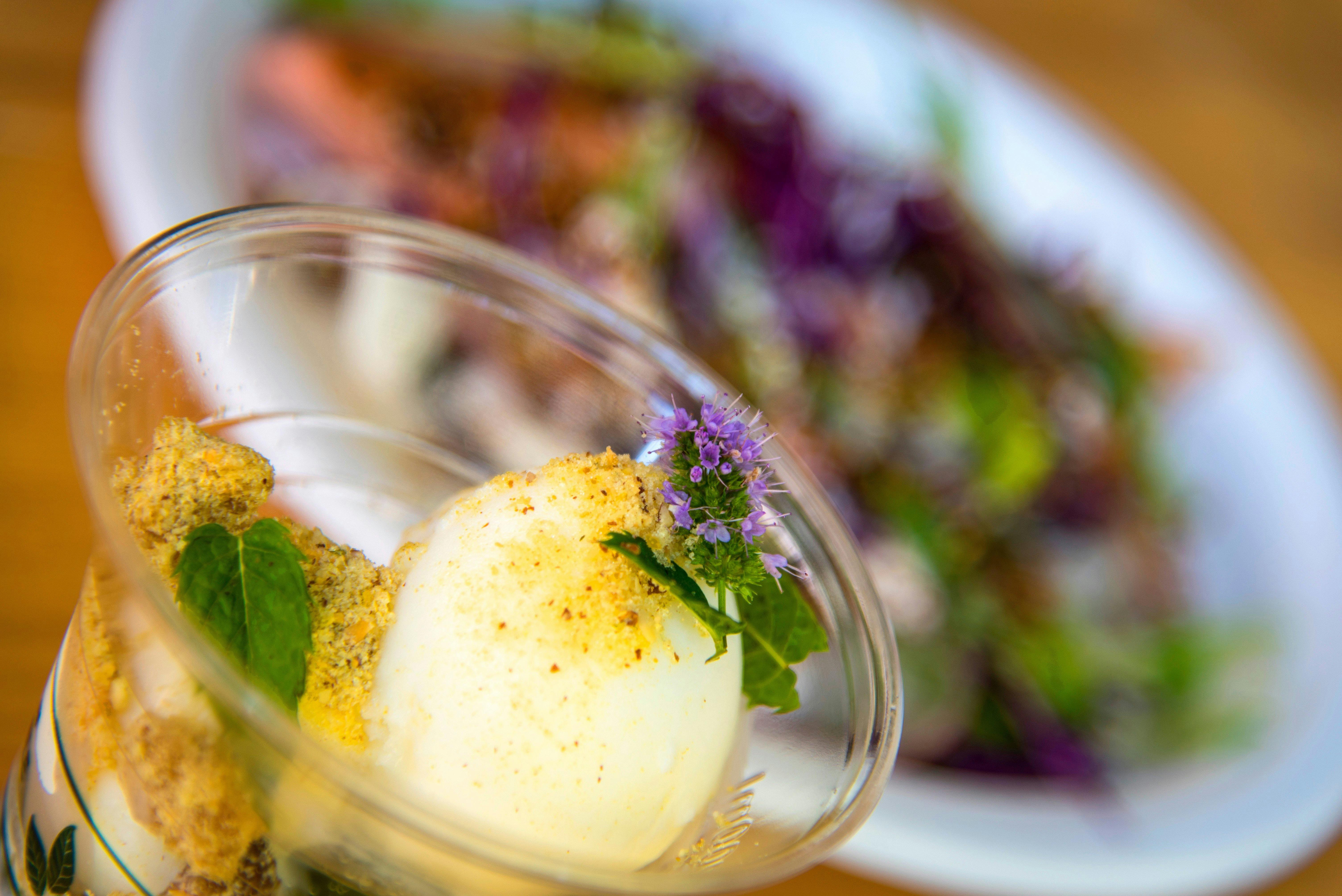Dessert cup and food plate in background