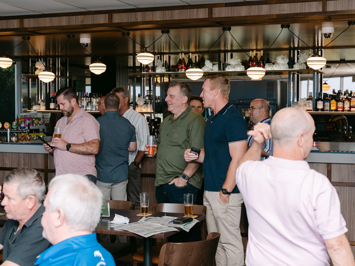 Men standing at a bar and talking