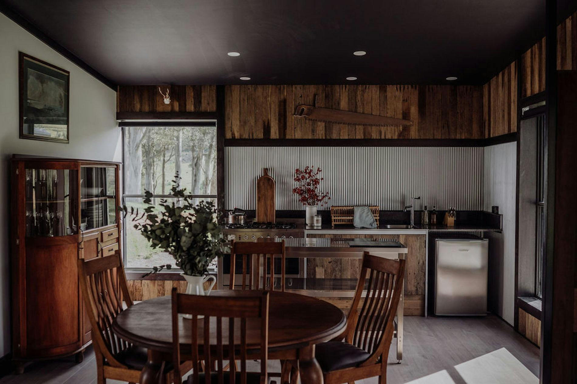 Dining table, open plan kitchen with rustic farmwear