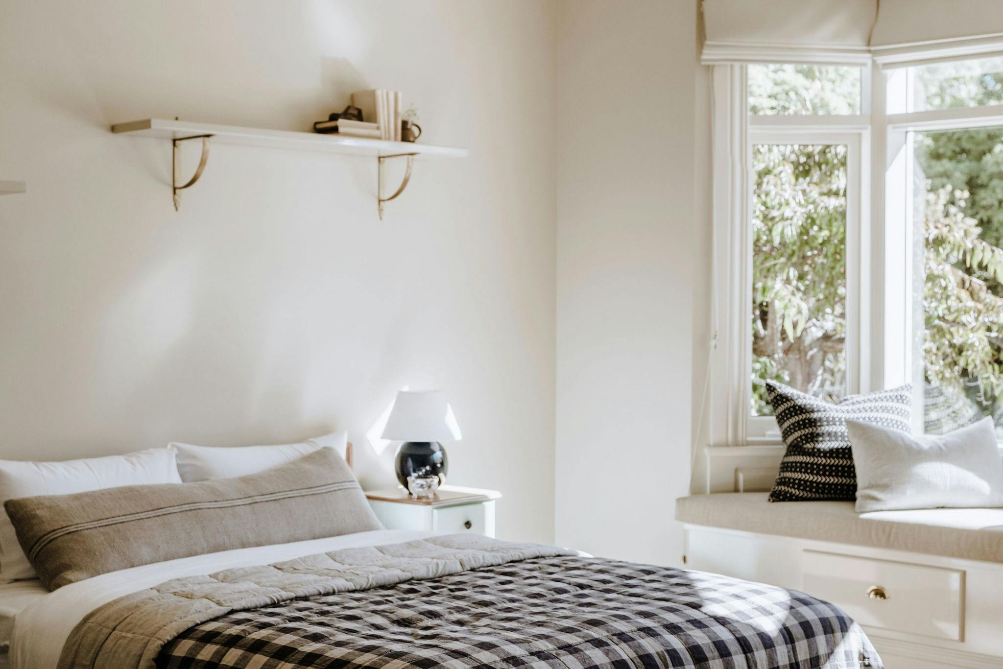 An image of the second bedroom and a glimpse of the garden view