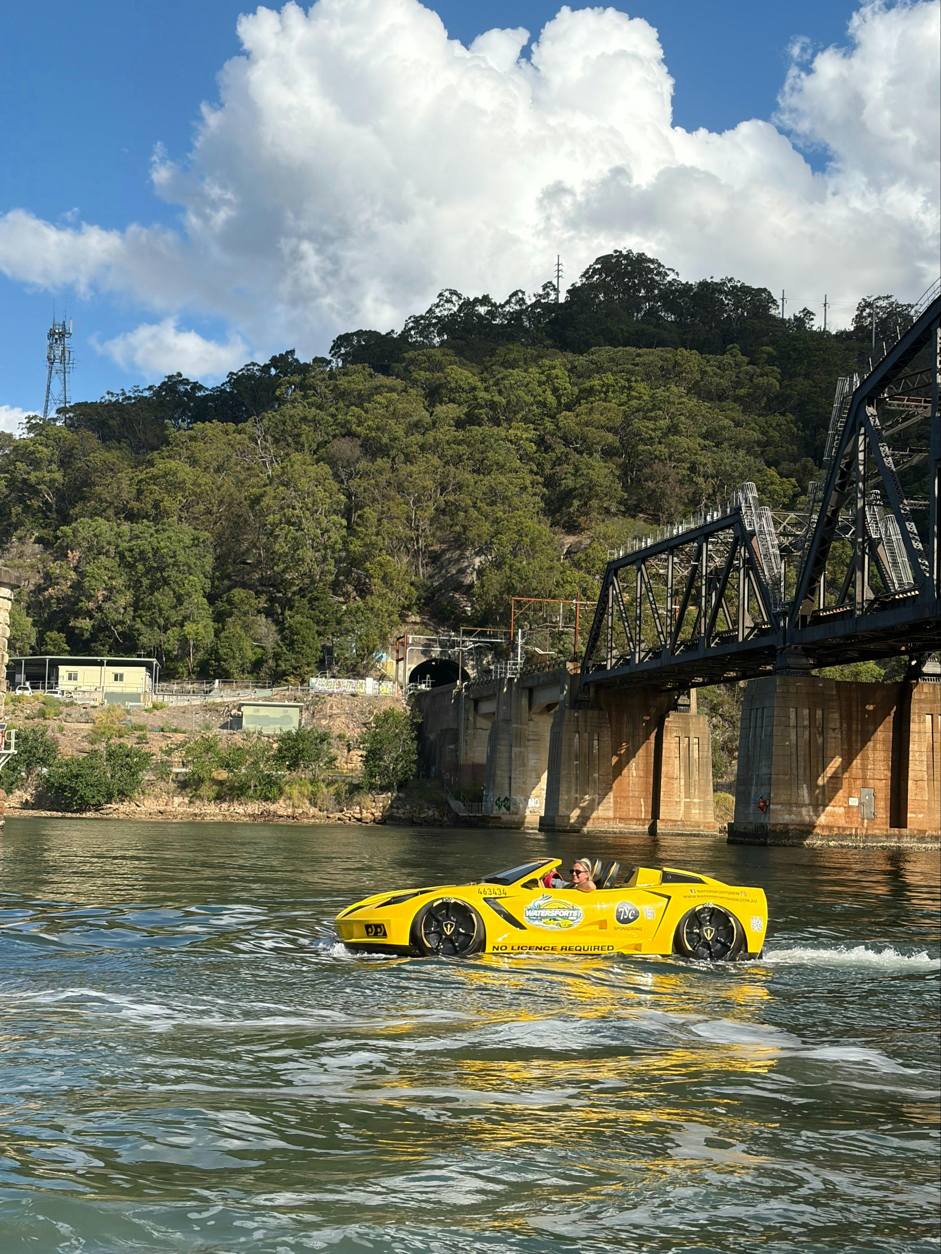 Yellow corevette jetcar under brooklyn railway bridge