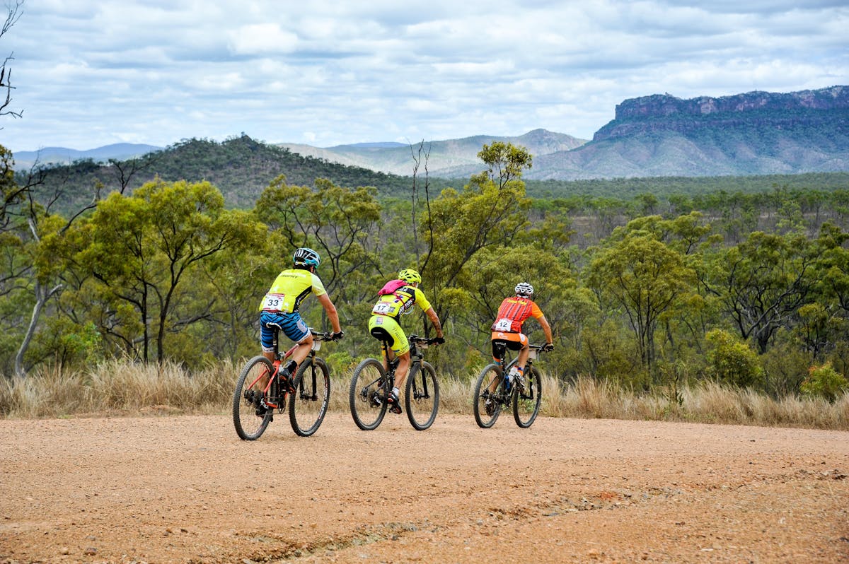 3 cyclists ride through Davies Creek National Park in Mareeba, Tropical North Queensland.