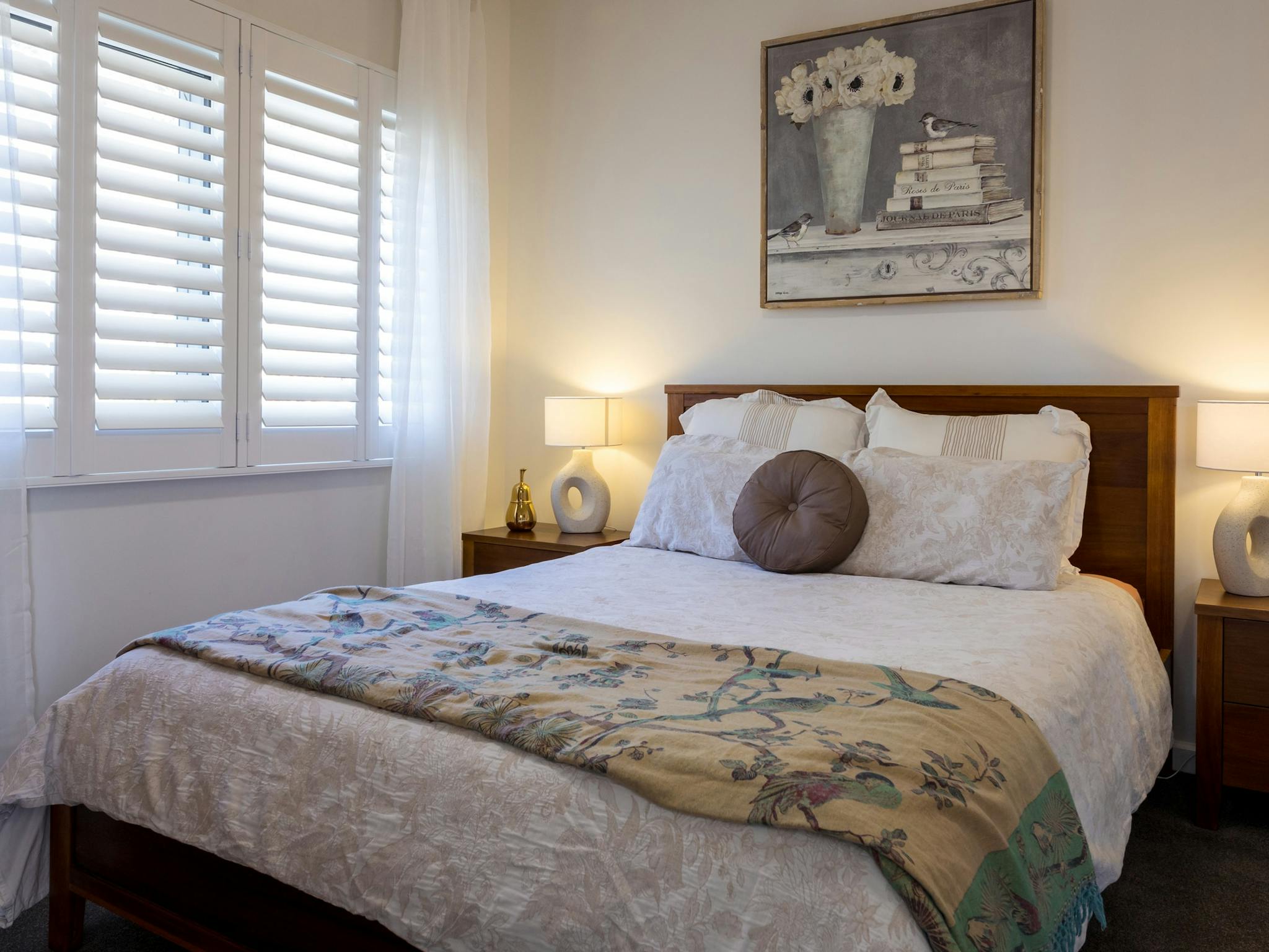 Bedroom, queen size bed, pillows, lamp, plantation shutters