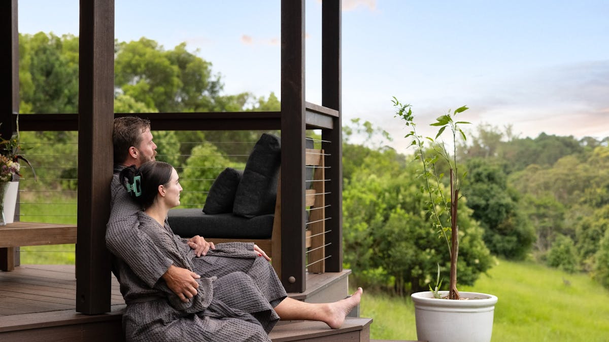 Couple relaxing on outdoor deck at The Range Holistic Spa and Wellness, Montville hinterland