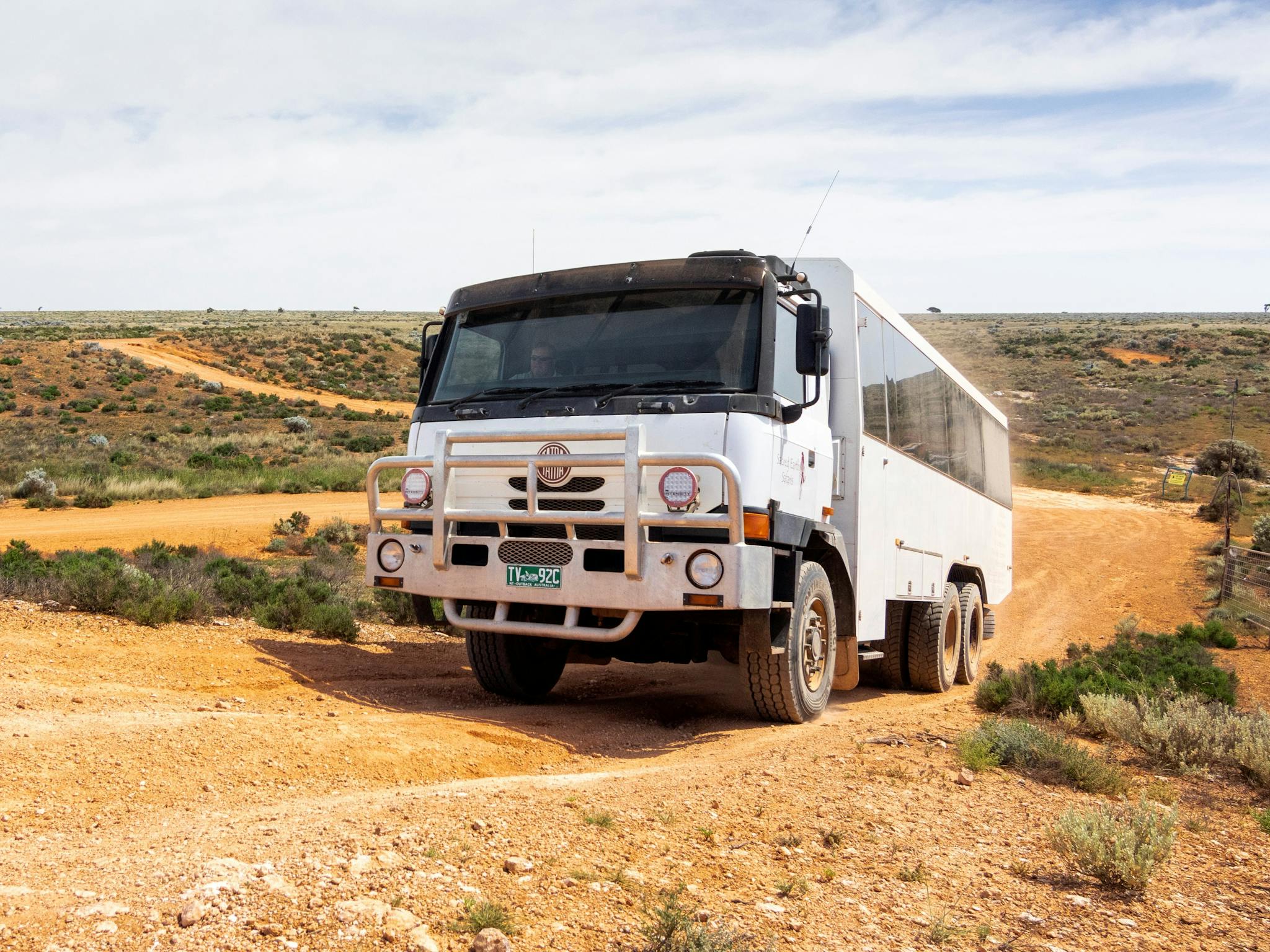 large 6WD coach driving on a dirt road