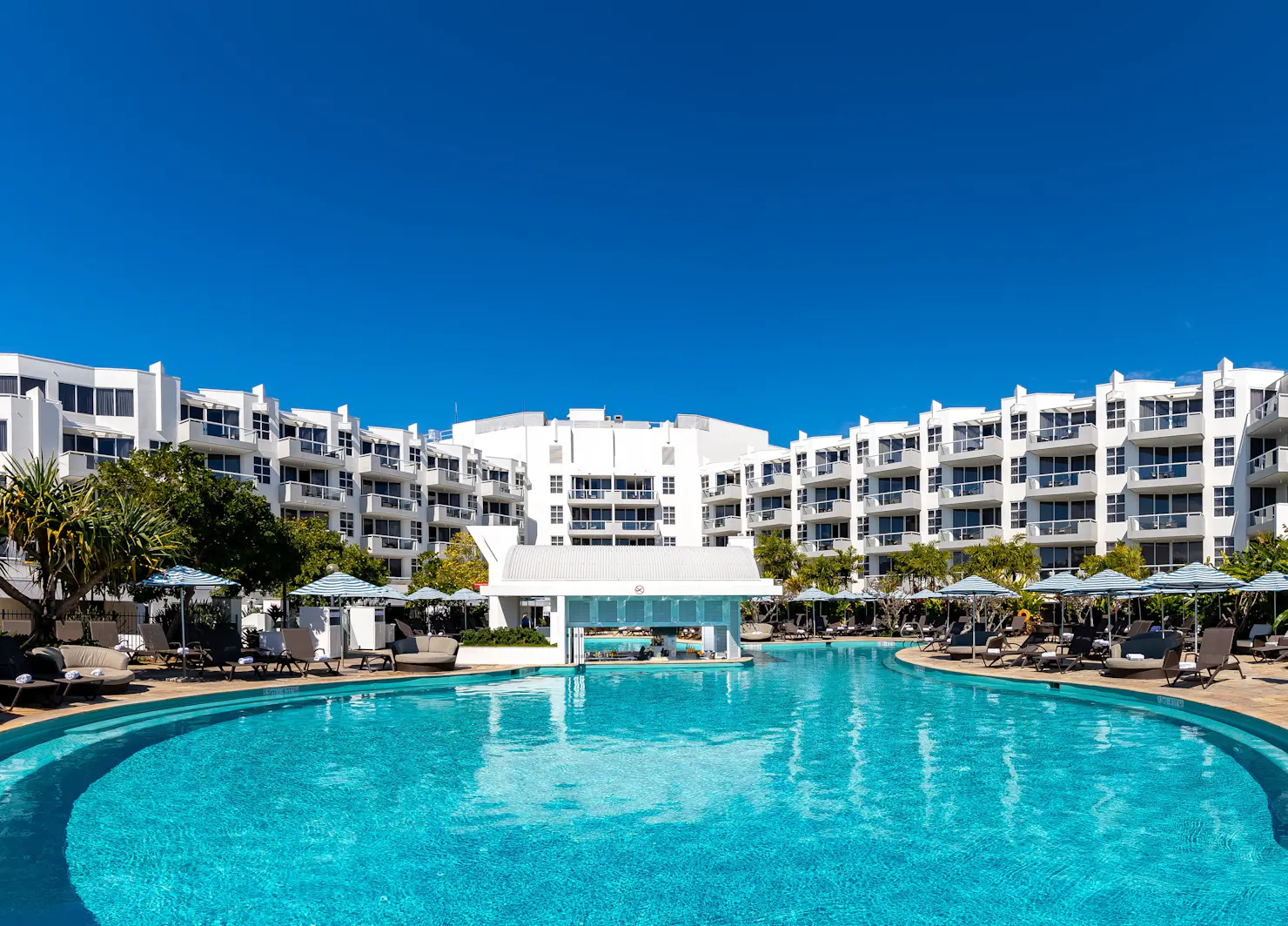 Resort style swimming pool with tropical swim up bar. Sofitel Noosa accommodation overlooks pool.