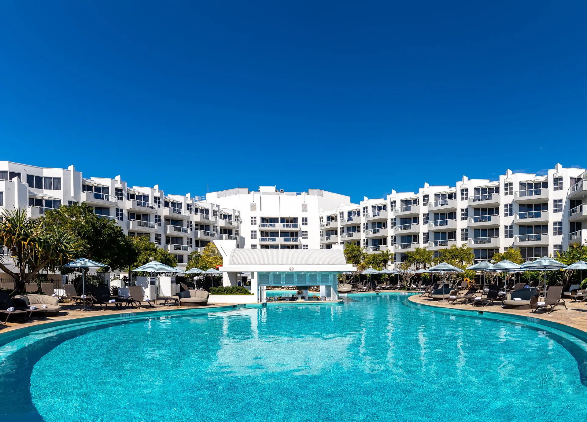 Resort style swimming pool with tropical swim up bar. Sofitel Noosa accommodation overlooks pool.