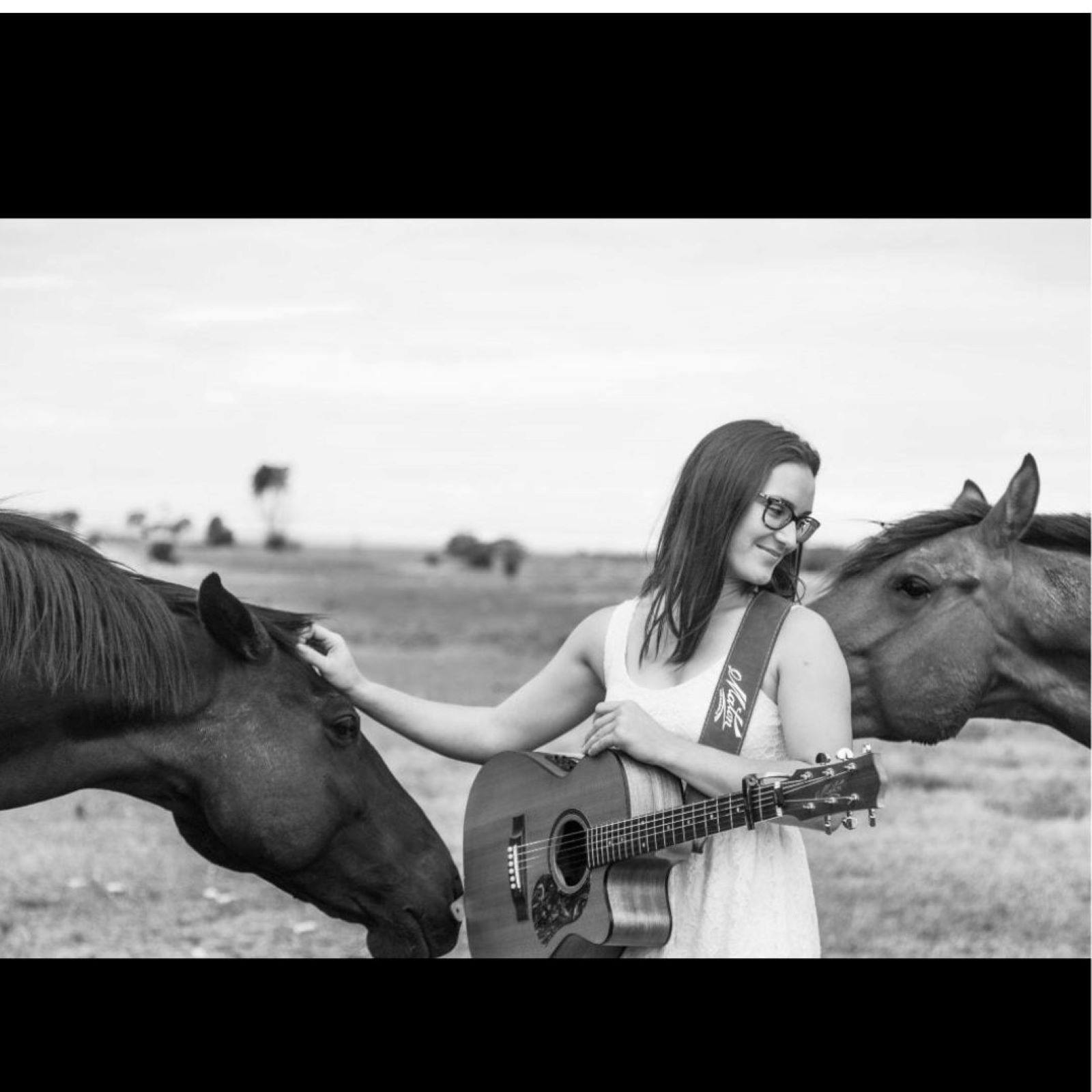 Girl with guitar and horses