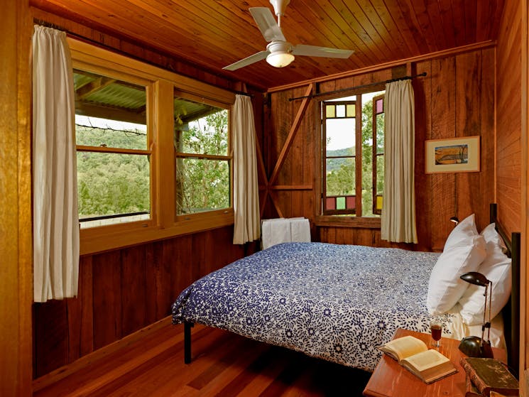 Cedar Creek Cottages bedroom with views over the vineyard and valley