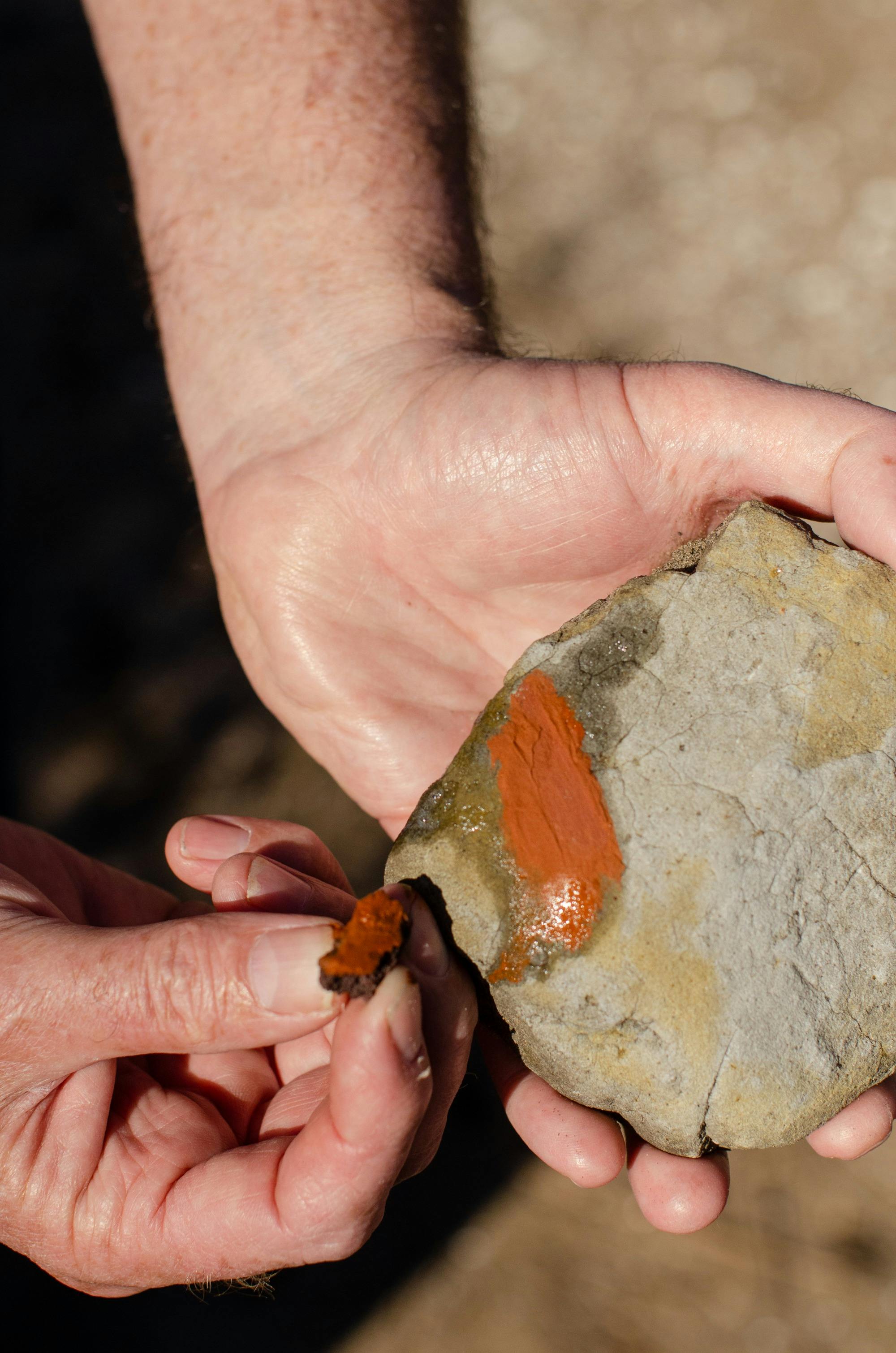 Red ochre held and rubbed onto another rock leaving a reddish brown streak
