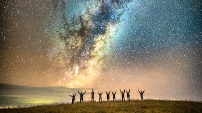 Astrophotographers posing under the Milky Way