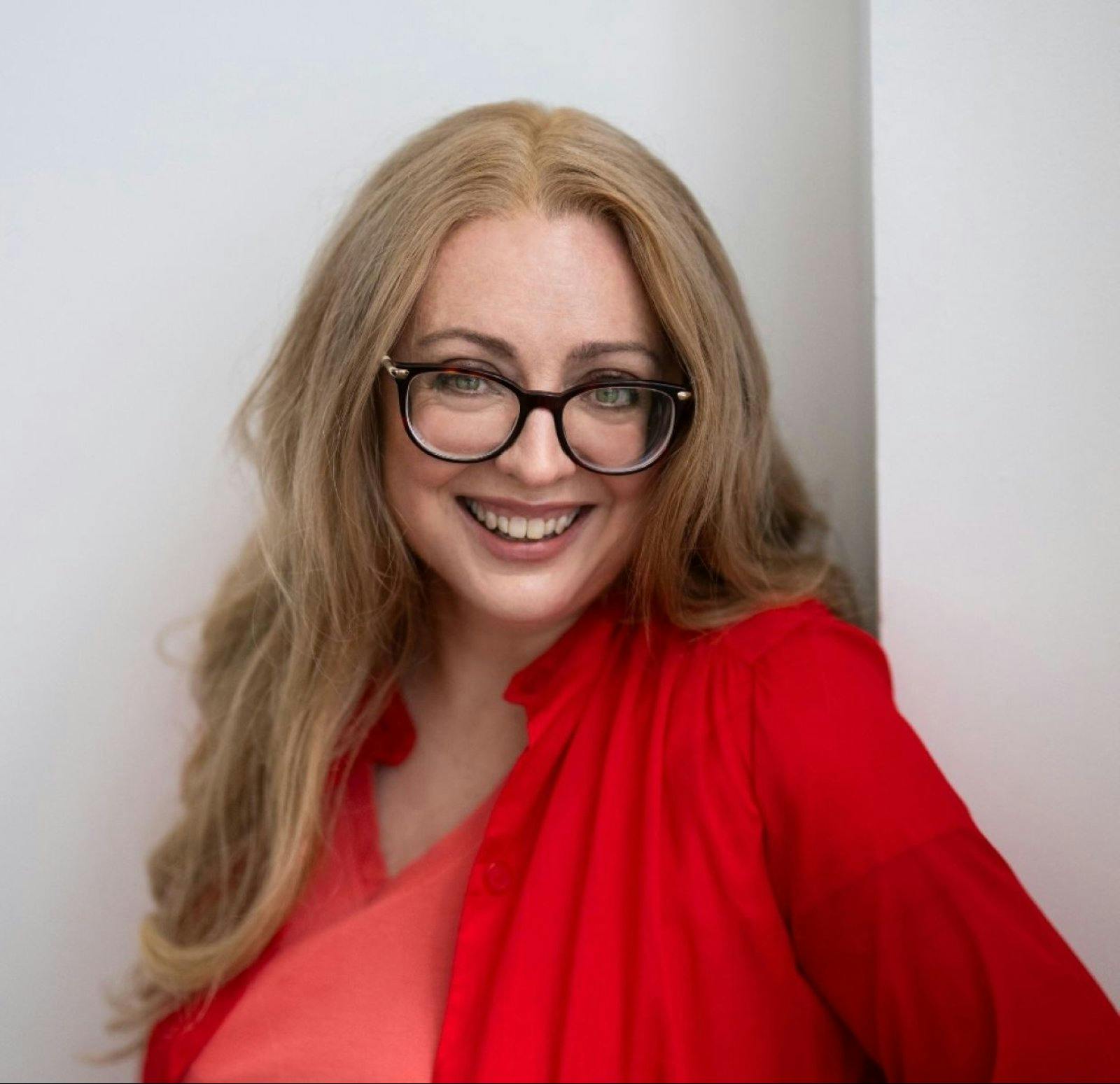 a lady facing the camera and smiling
