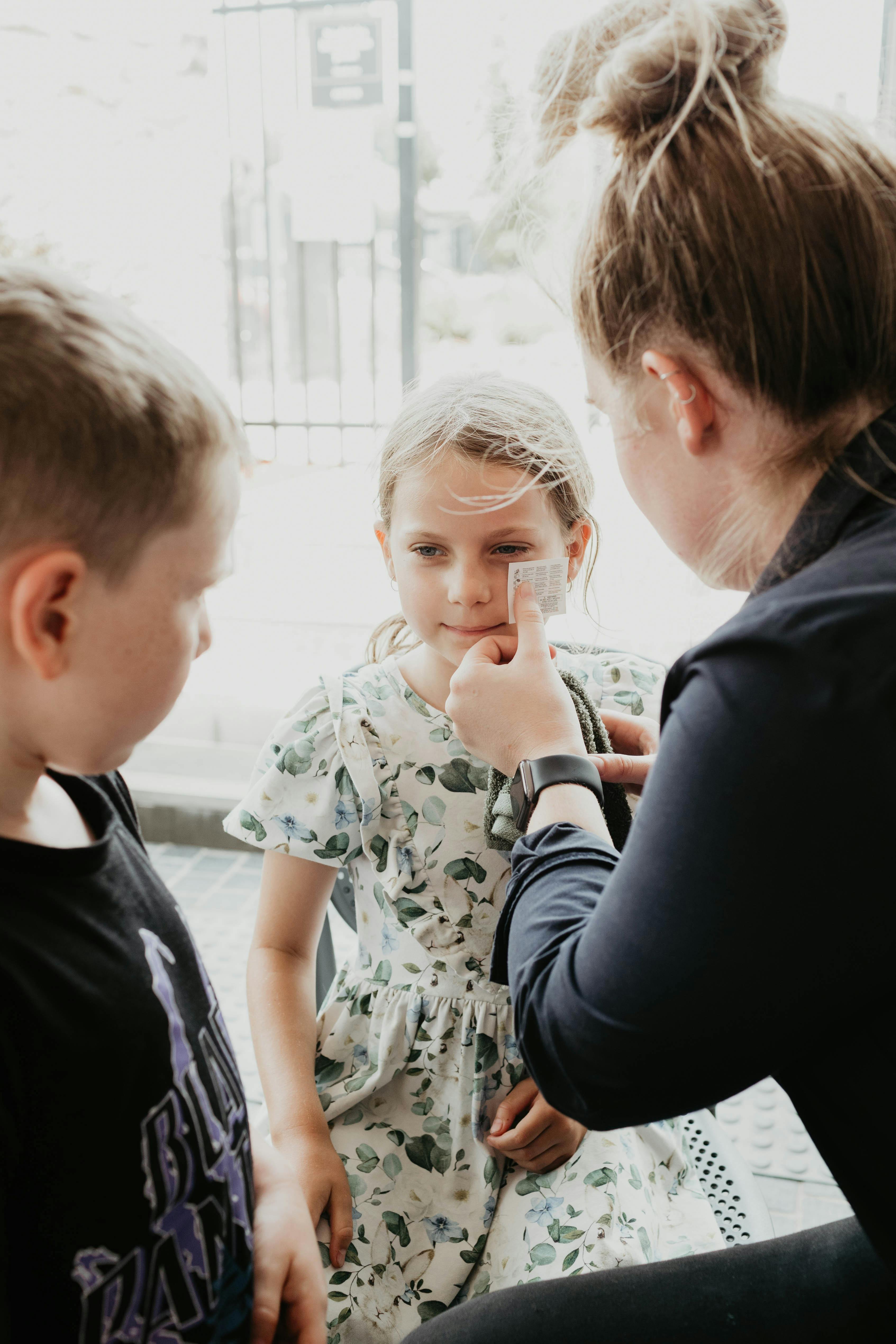 Child getting temporary tattoo by staff member