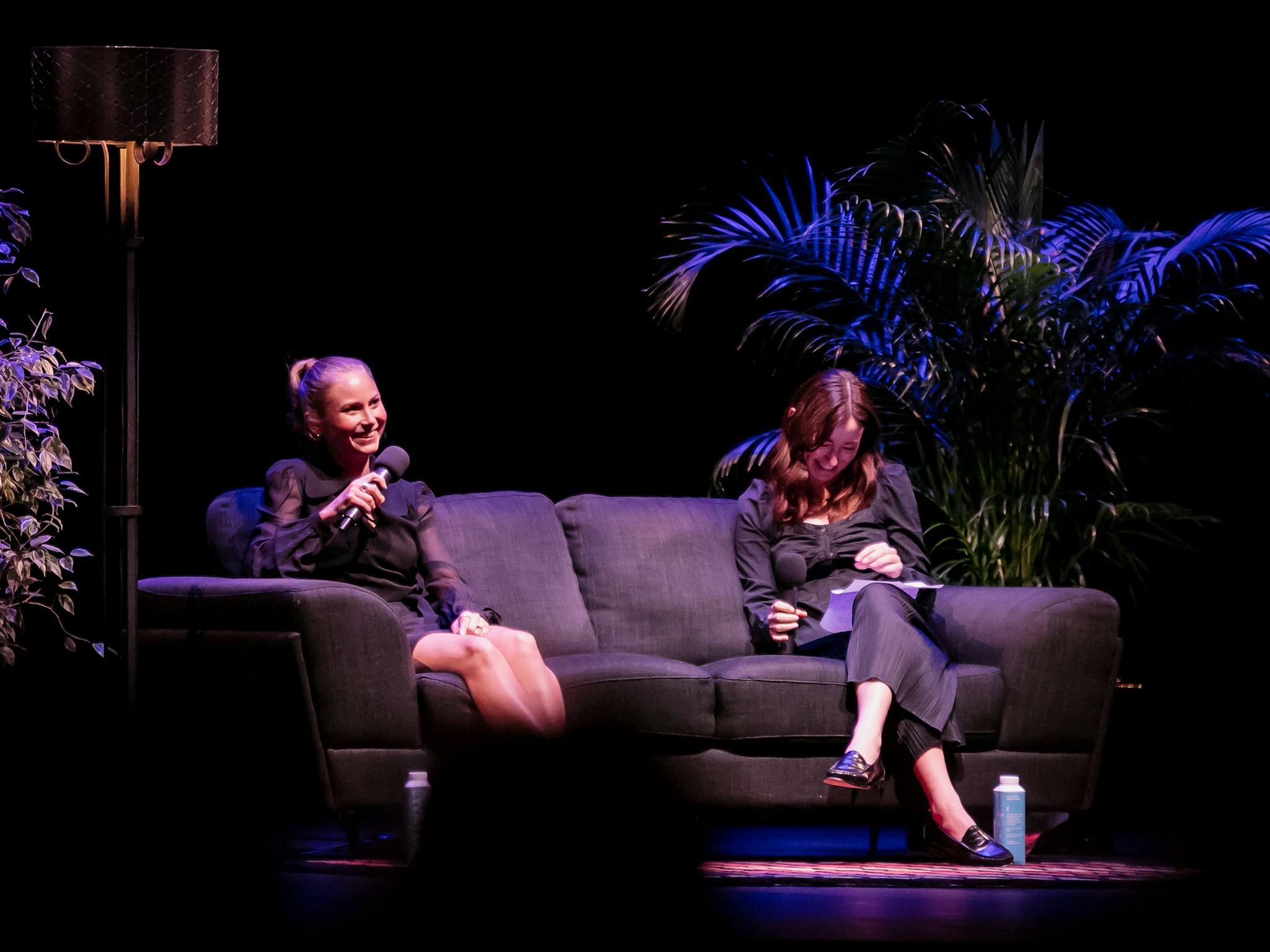 Activist Grace Tame sits beside event host Maddison Connaughton on a lounge on stage.