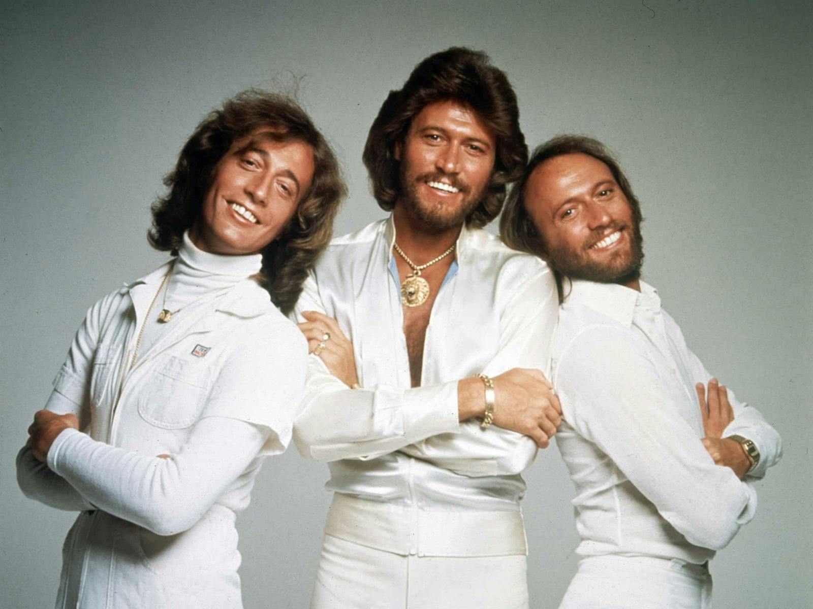 three men wearing white clothes