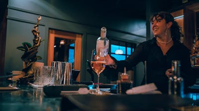 Bartender pouring glass of wine
