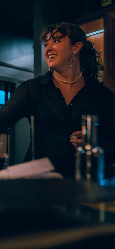 Bartender pouring glass of wine