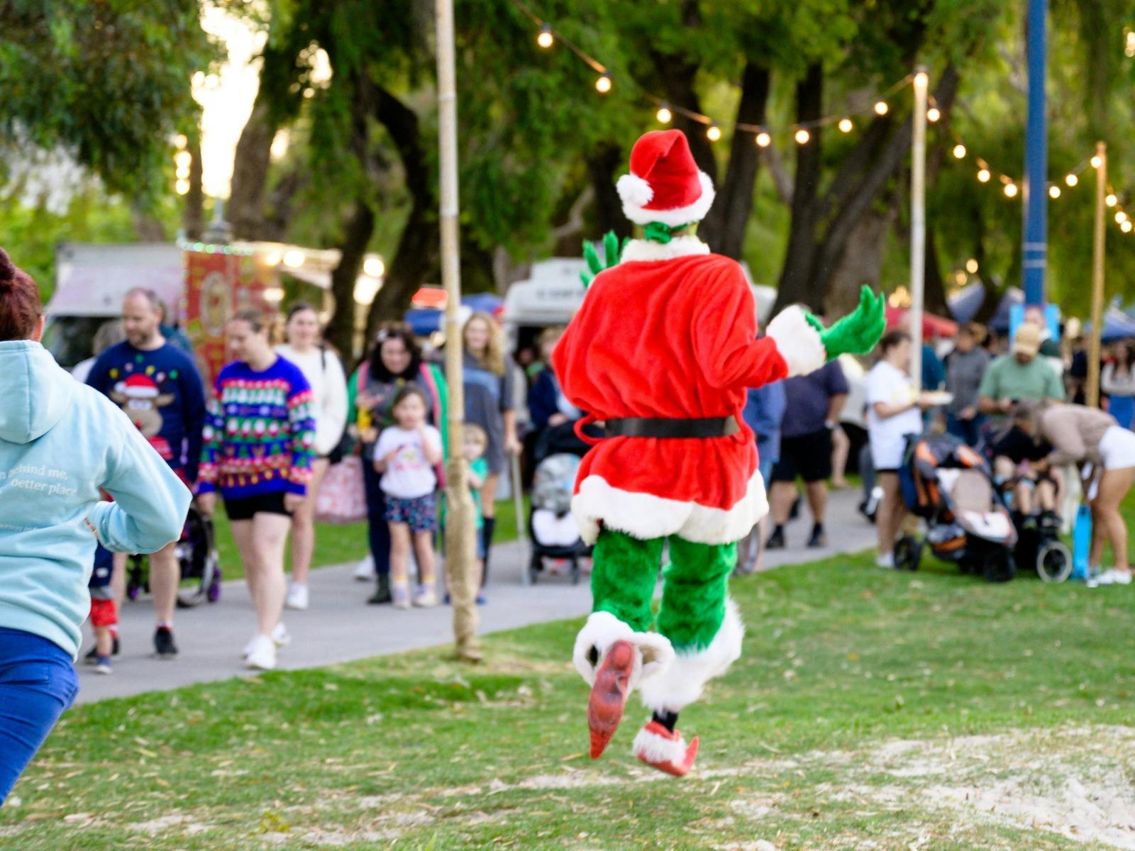 The grinch frolicking through the event