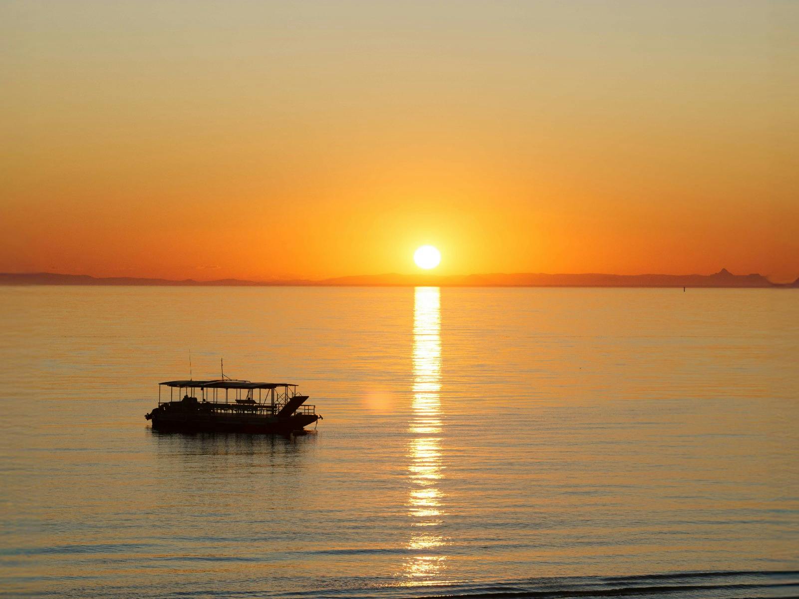 Boat sitting on the water with an or