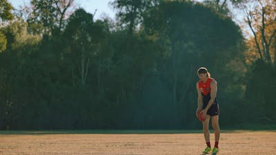 Man on field getting ready to kick a football