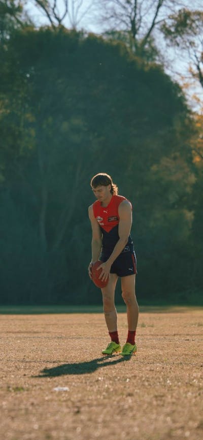 Man on field getting ready to kick a football