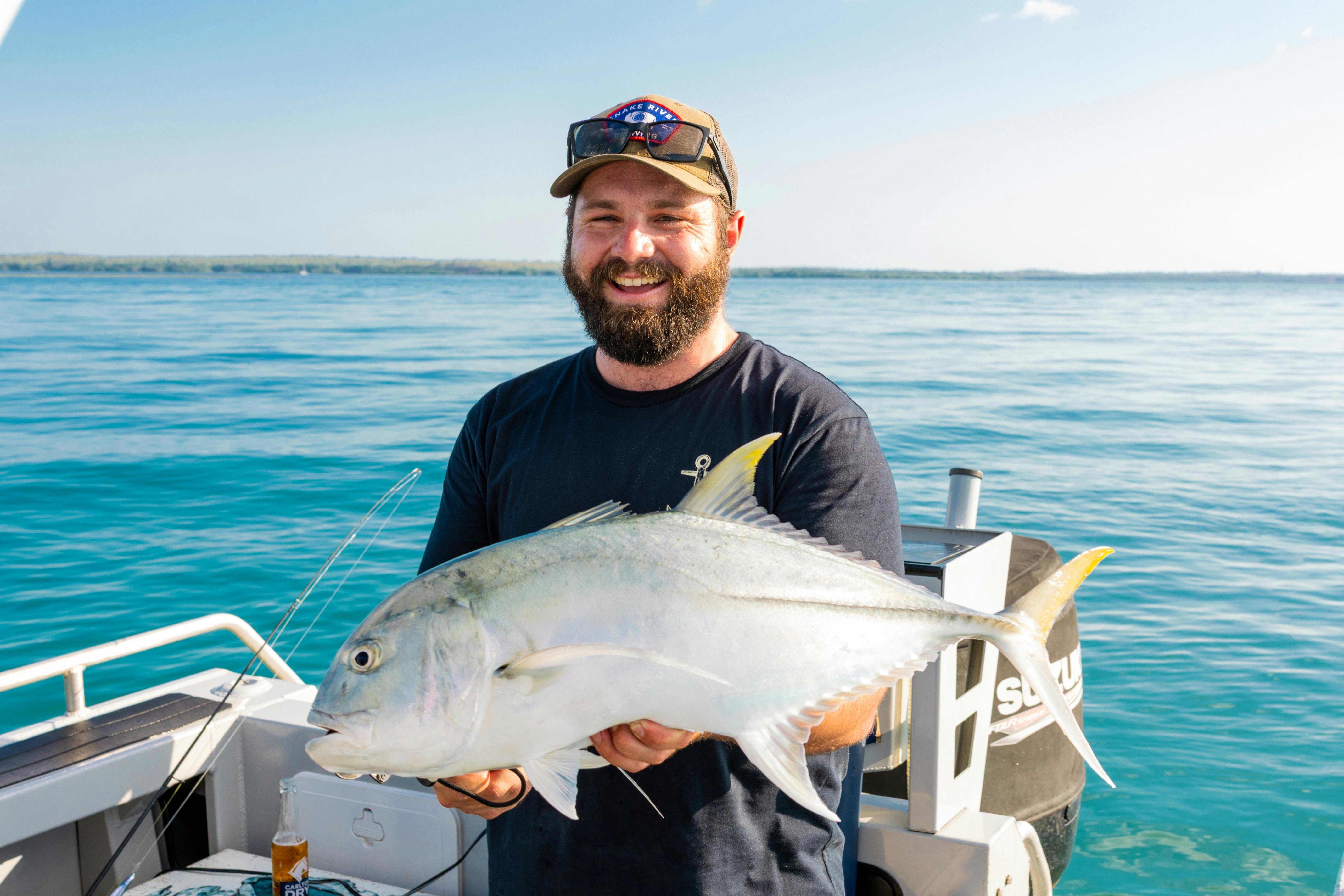 Giant trevally caught on Darwin Harbour, displaying its powerful build and silvery-grey scales.