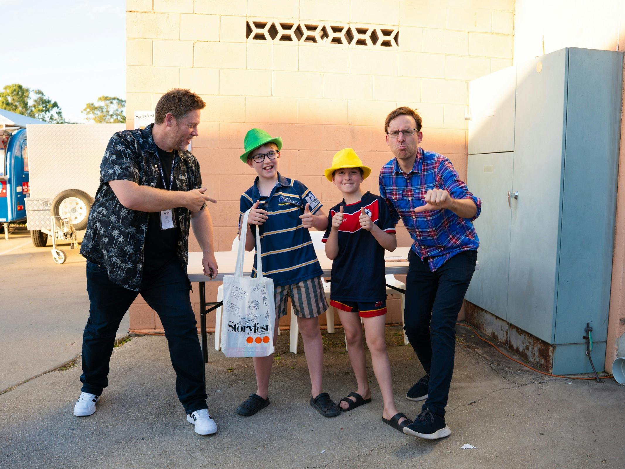 Authors and young readers pose together at the Storyfest Central QLD Prologue Party.