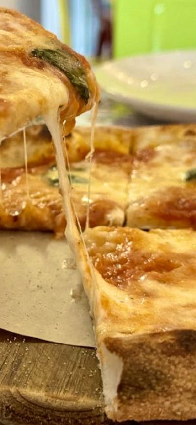 Slice of pizza with melted cheese