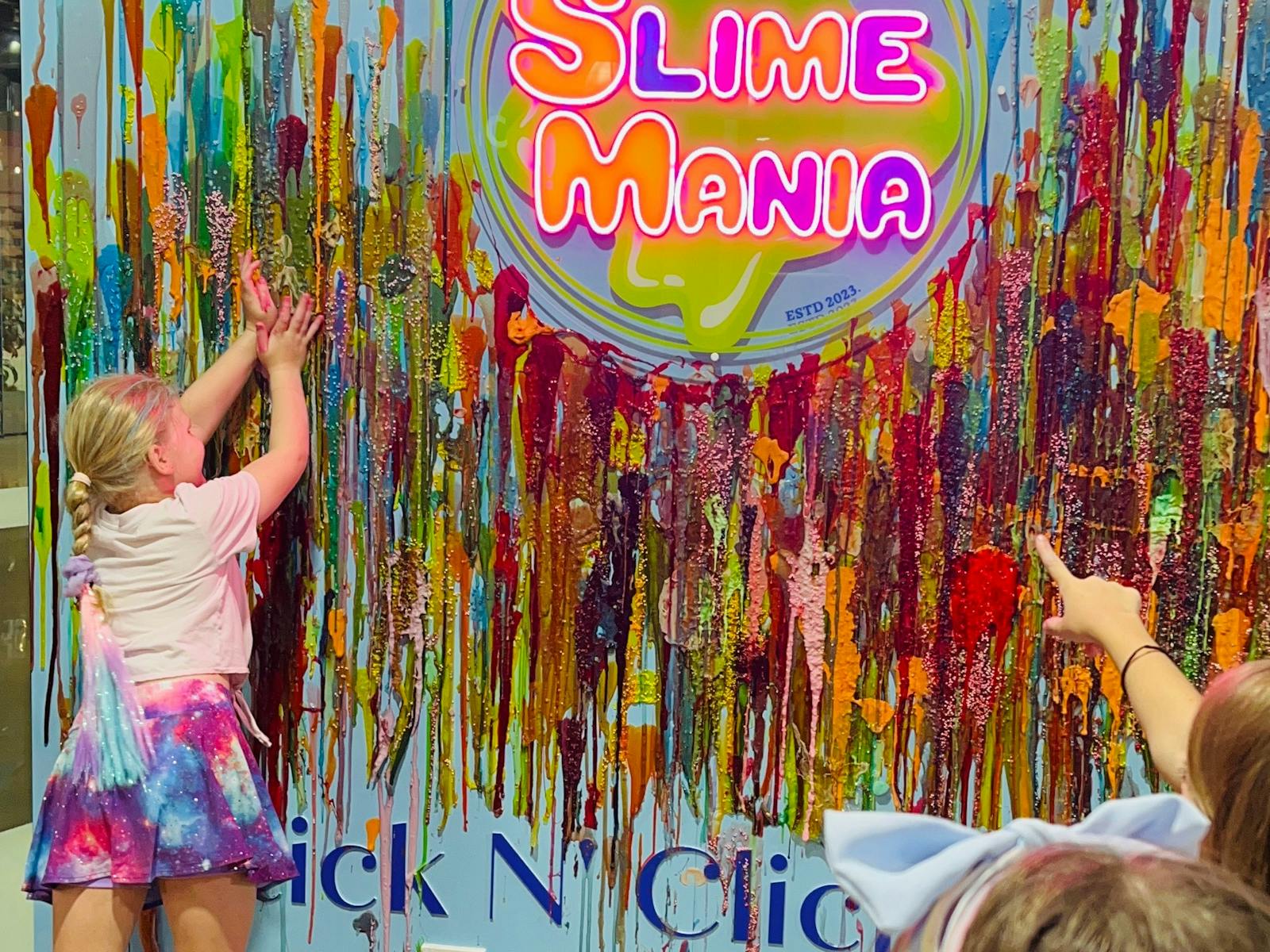 Slime wall where we have a Slime Mania logo and there is a girl sticking her favourite slime. Slime wall where we have a Slime Mania logo and there is a girl sticking her favourite slime.