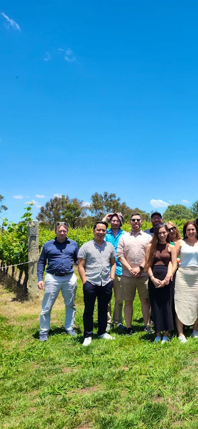 A diverse group of individuals standing together in a vast field, showcasing unity and togetherness.