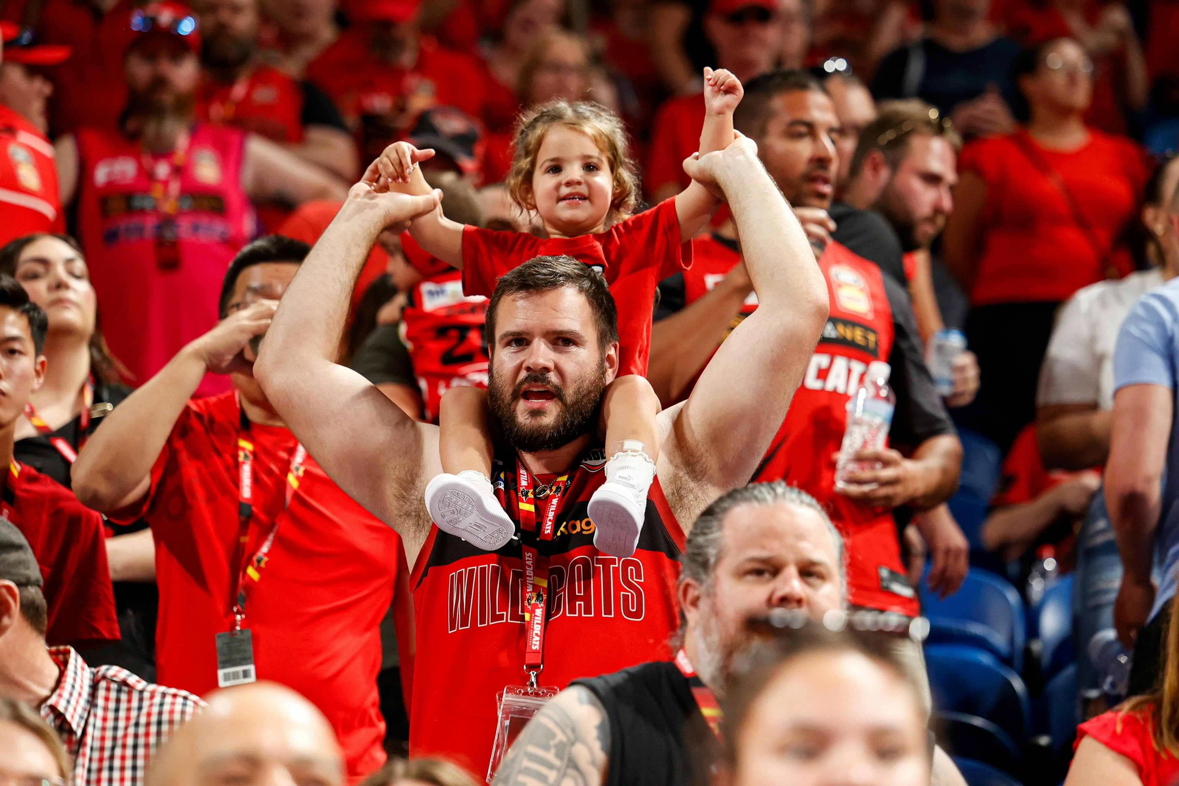 A father carries his daughter on his shoulders in the crowd at RAC Arena