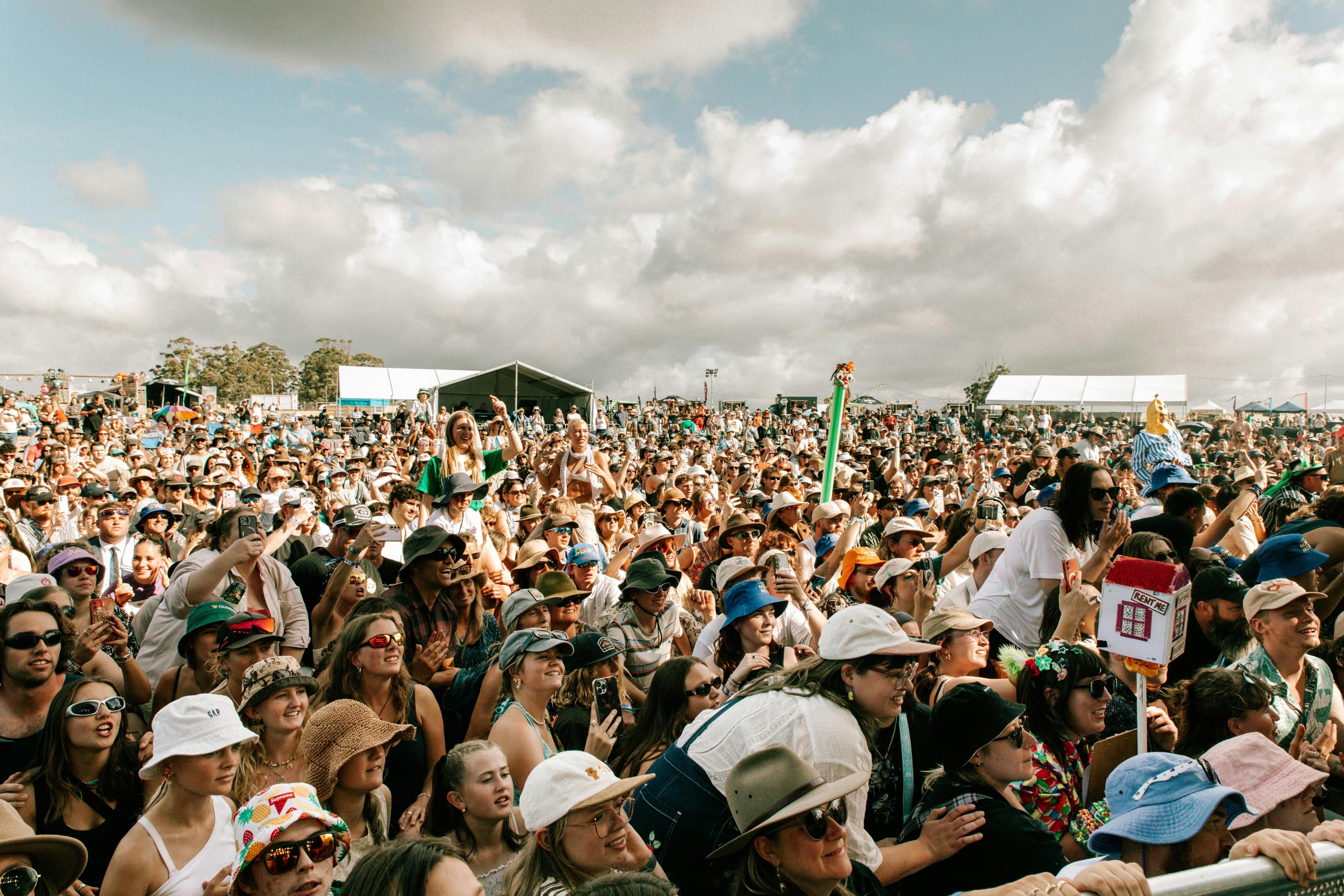 Festivalgoers smiling and cheering in a packed daytime crowd at Good Gumnuts Festival.