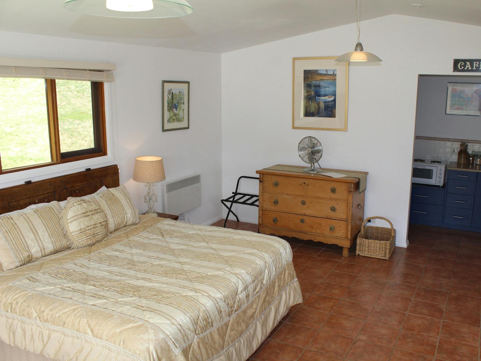 View of King sized bed and fulyequipped kitchen