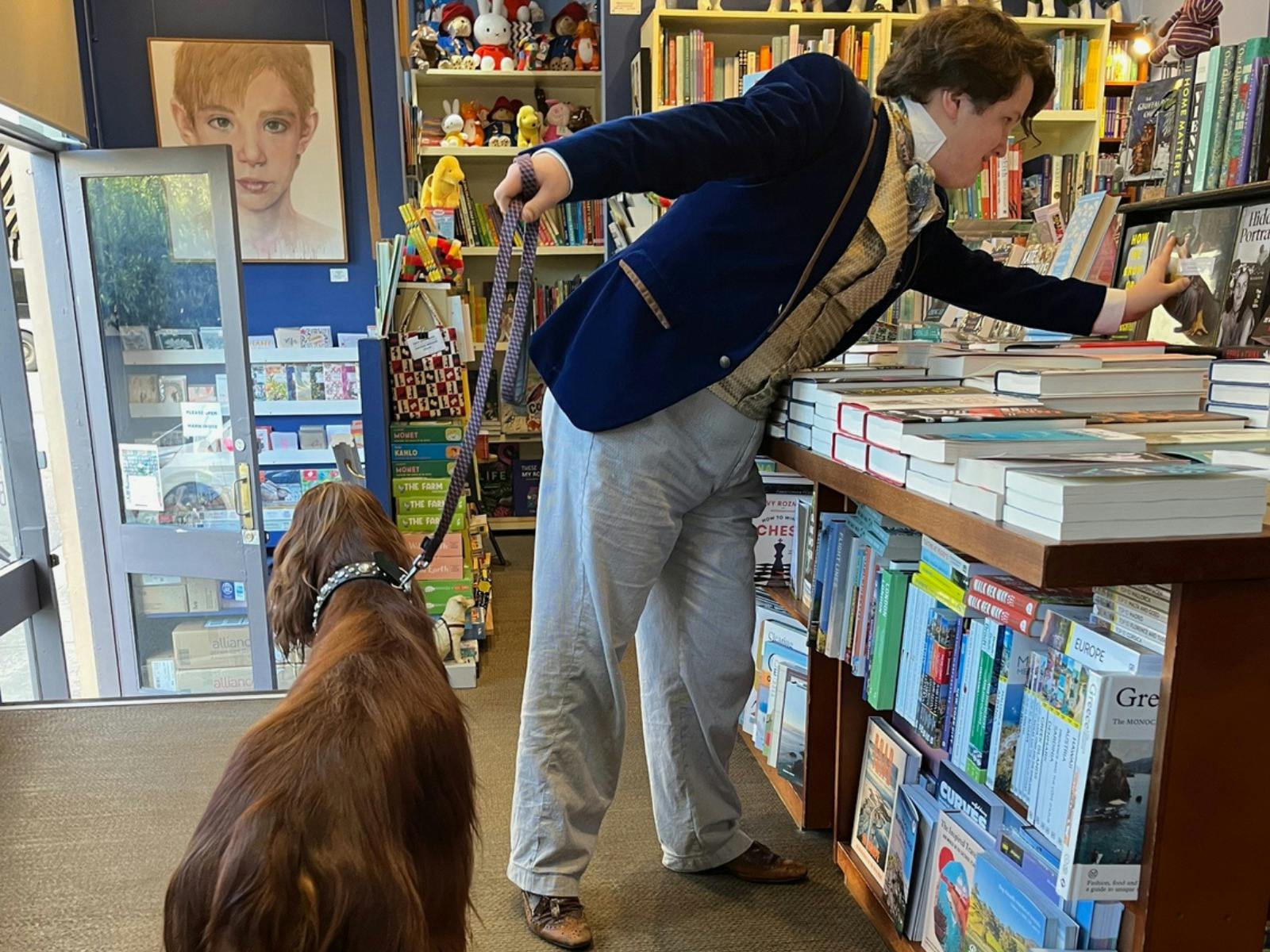 young man dressed in fashionable clothes and his dog at Woollahra Bookshop
