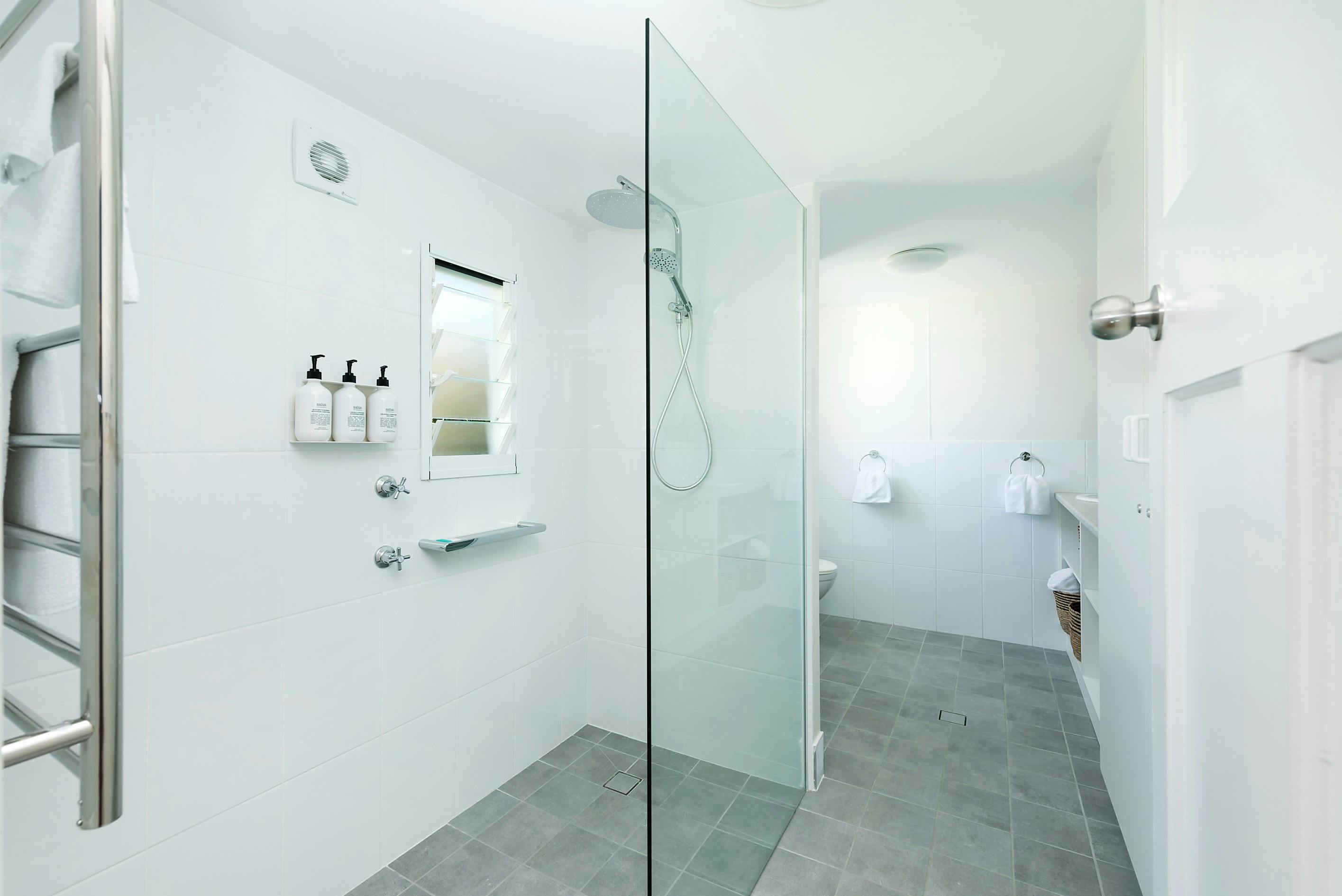 Updated bathroom with walkin shower, euro laundry and lots of vanity storage