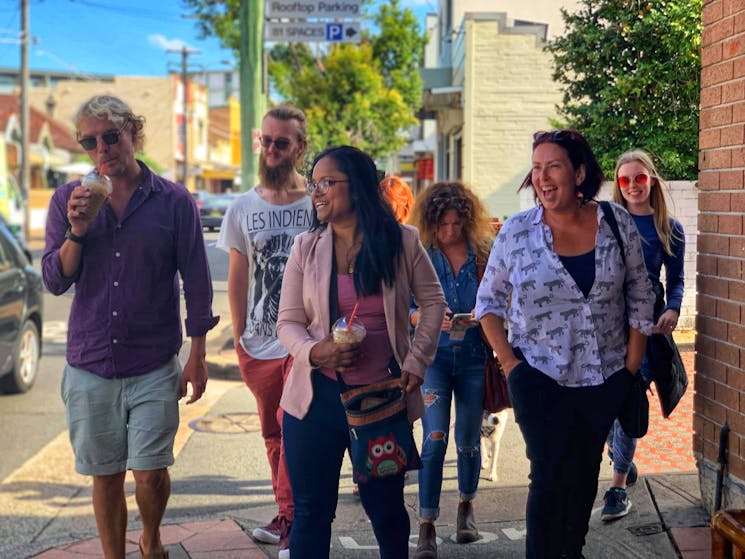 ID tour group walking through the streets of Marrickville and laughing at the guide's stories
